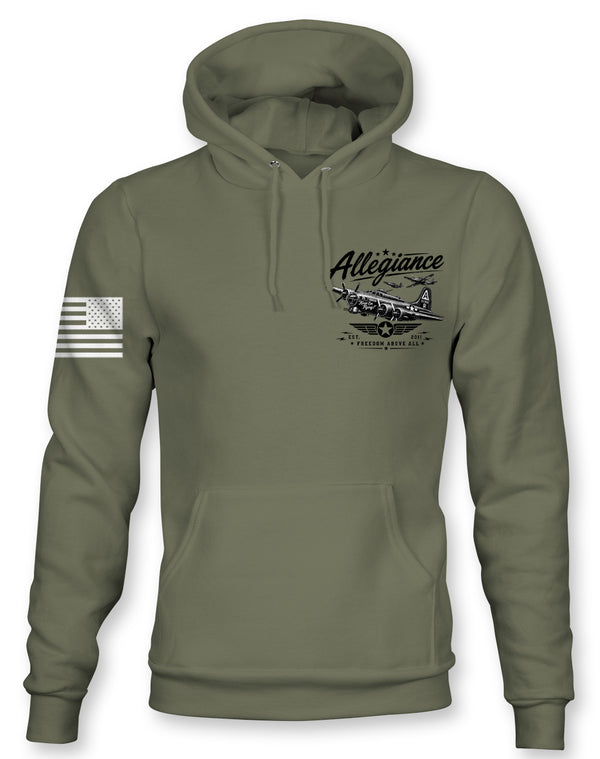 An olive green pullover hoodie with a black graphic on the left chest depicting a vintage airplane and the word 'Alliance', along with a distressed black-and-white American flag graphic on the right sleeve.
