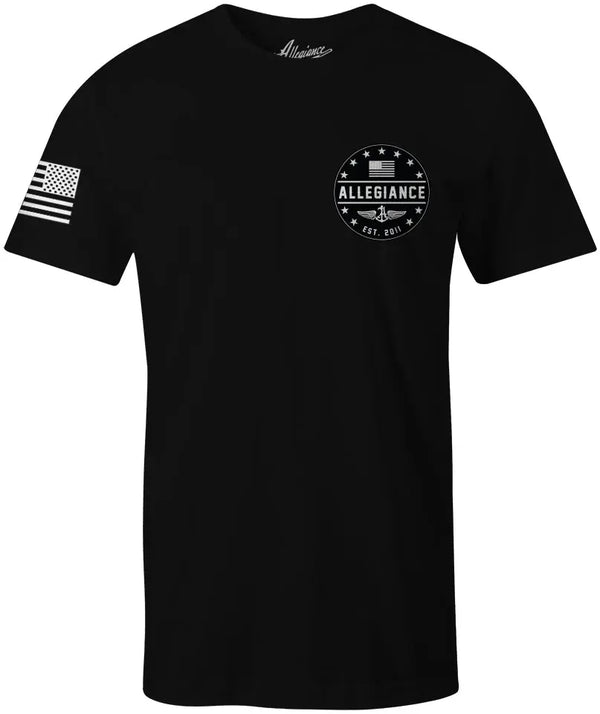 Front of EST. 11 Back Hit Tee in black featuring small "EST. 11" chest graphic and American flag on the sleeve.